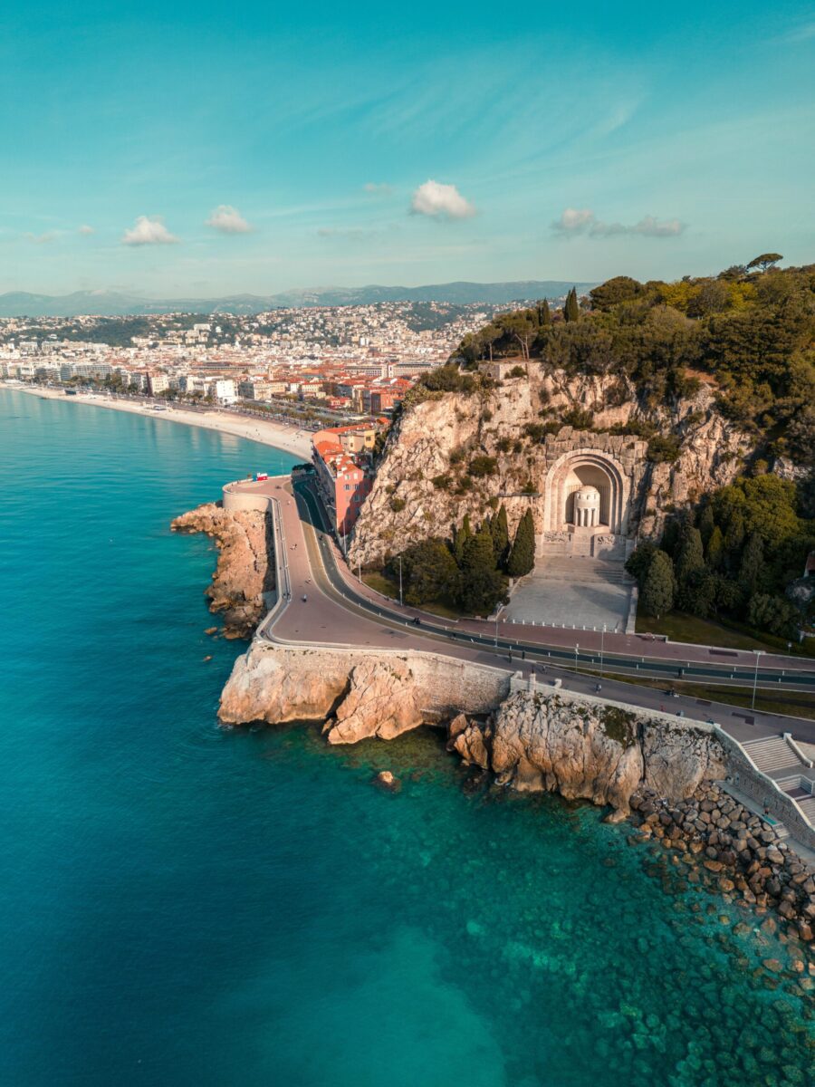 Stunning aerial photograph of Nice's coastline featuring a famous memorial archway.