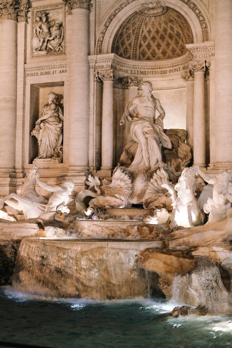Stunning night view of the iconic Trevi Fountain in Rome, showcasing its intricate sculptures.